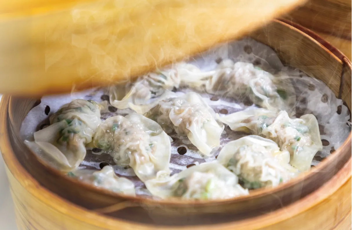 Gyoza steamed in a bamboo steamer
